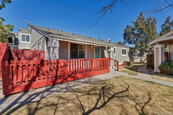 a view of a house with wooden fence