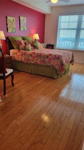 a bedroom with a bed and a potted plant