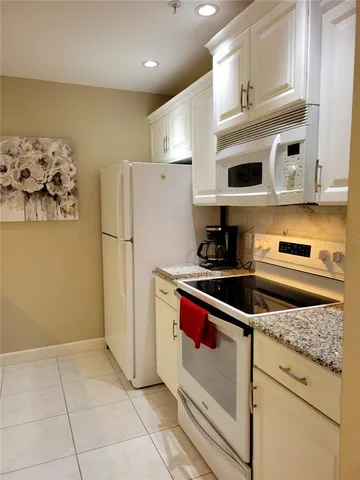 a kitchen with granite countertop a sink and cabinets