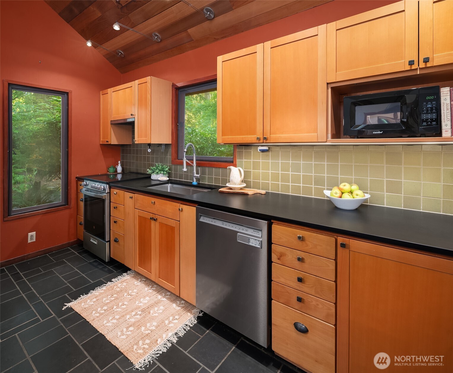 17804 Thorsen Road Southwest Vashon, WA 98070 - Photo 18 of 39 a kitchen with granite countertop a sink window and cabinets