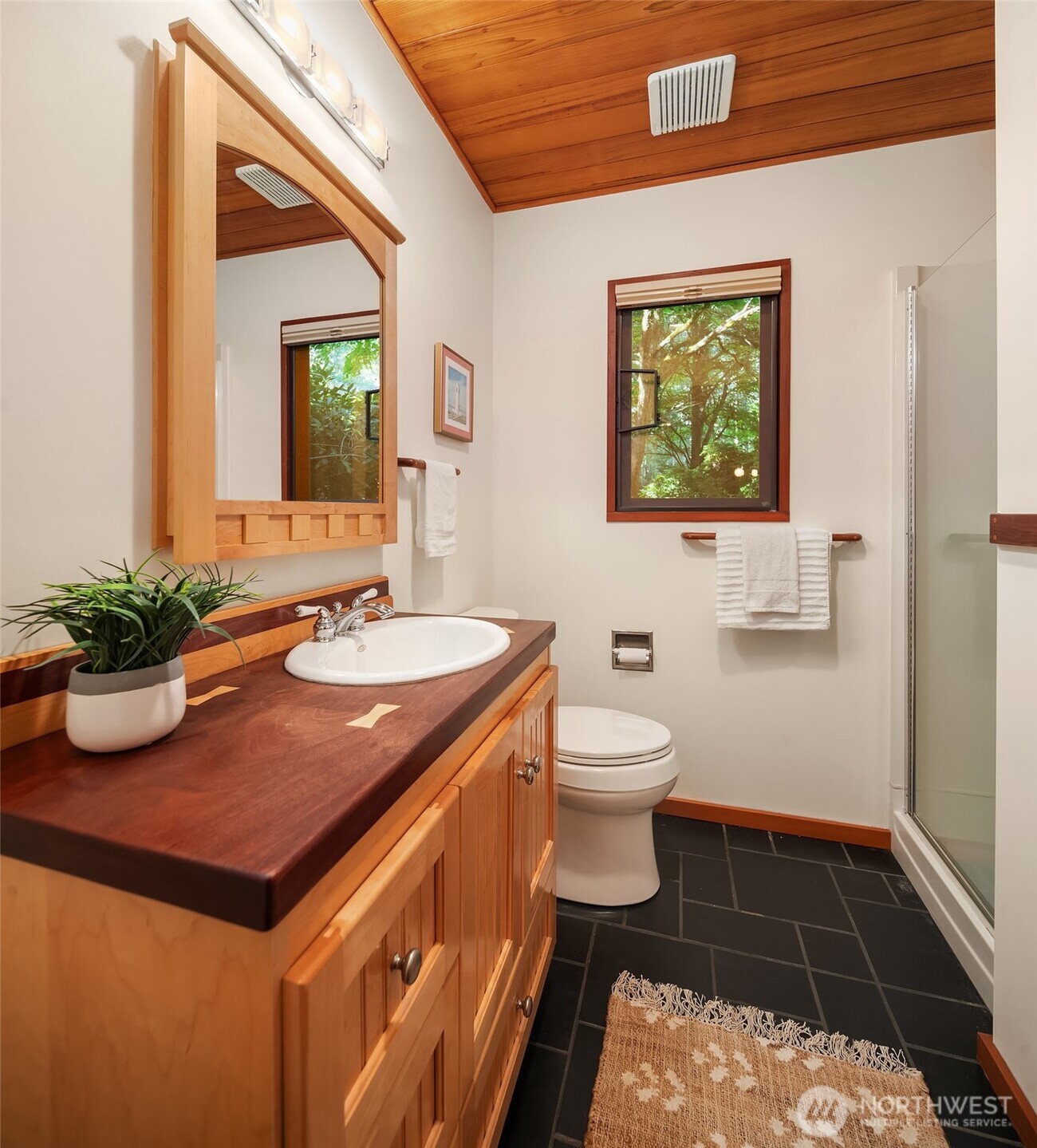 17804 Thorsen Road Southwest Vashon, WA 98070 - Photo 23 of 39 a bathroom with a sink a toilet and mirror