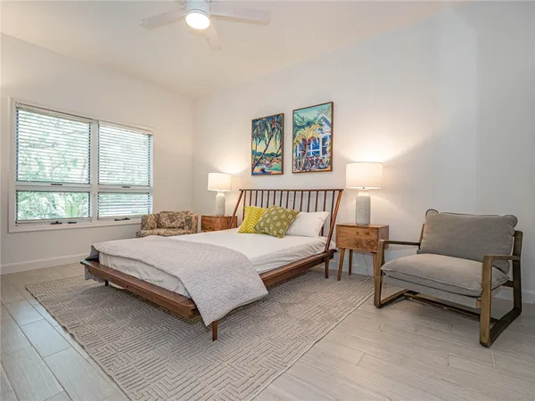 a spacious bedroom with a bed and a couch