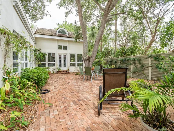 a view of a house with backyard and sitting area