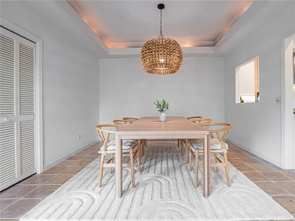 a view of a dining room with a table and chairs