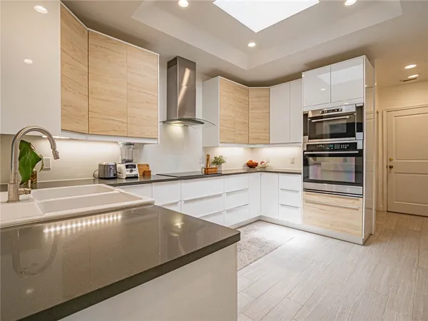 a kitchen with kitchen island a counter space a sink and appliances