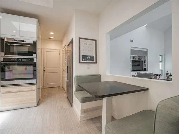 a kitchen with stainless steel appliances granite countertop a stove a refrigerator a sink a microwave and a refrigerator