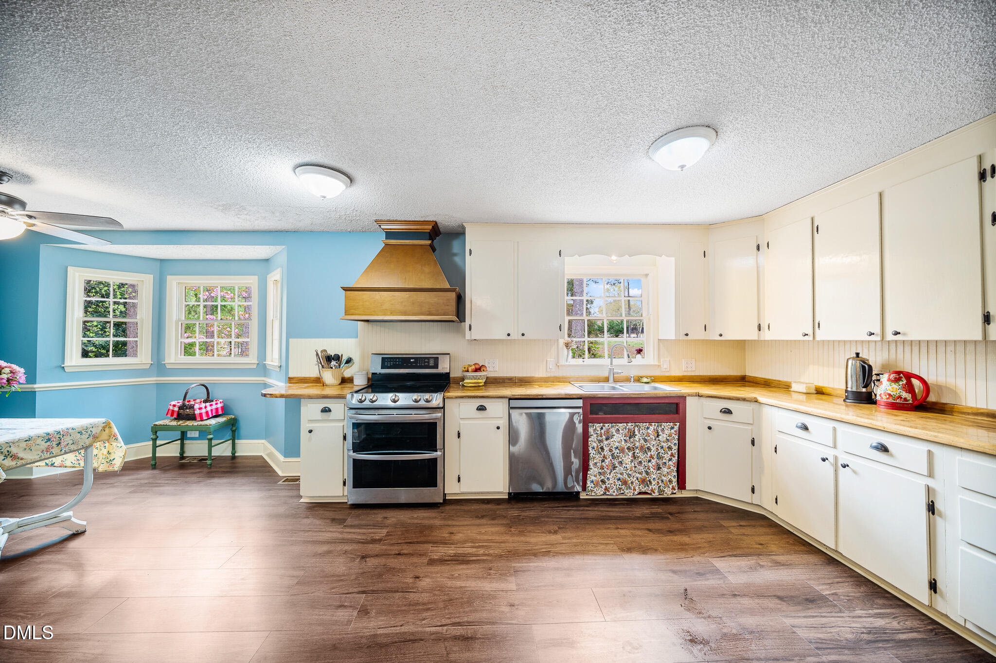 79 South Pleasant Street Angier, NC 27501 - Photo 12 of 52 a large kitchen with stainless steel appliances granite countertop a stove and cabinets