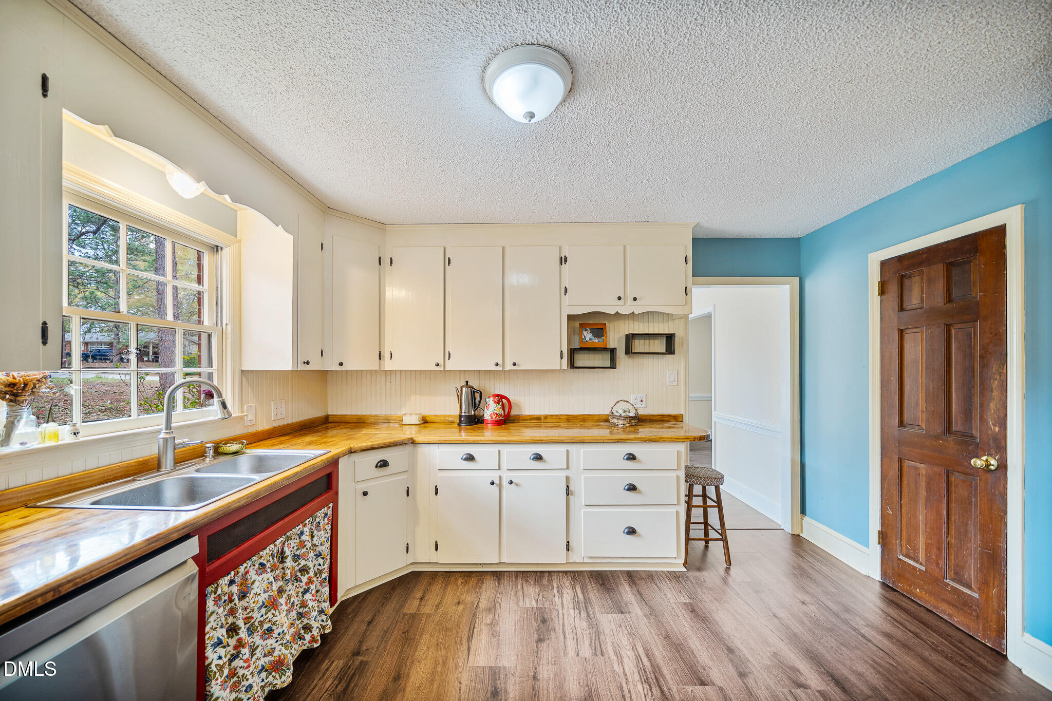 79 South Pleasant Street Angier, NC 27501 - Photo 13 of 52 a kitchen with wooden floors and appliances