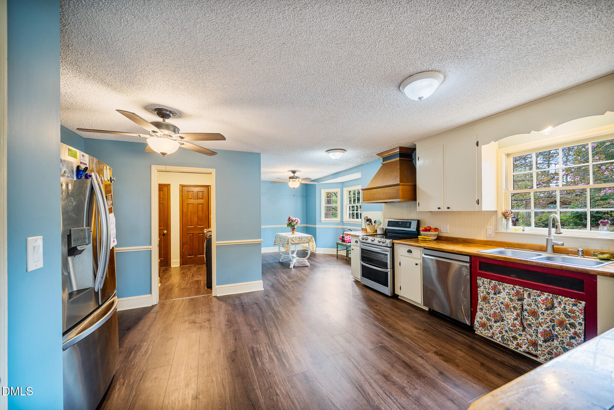 79 South Pleasant Street Angier, NC 27501 - Photo 15 of 52 a large kitchen with stainless steel appliances granite countertop a lot of counter space and wooden floors