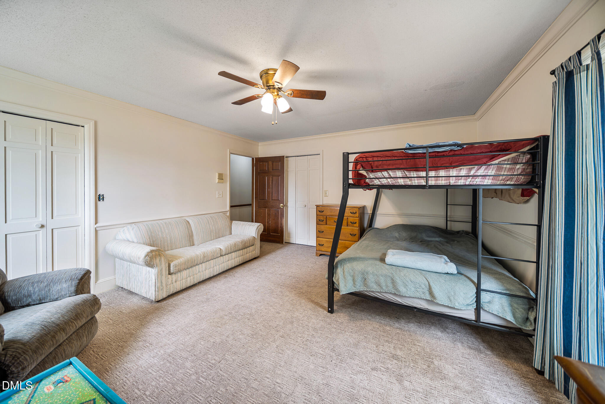 79 South Pleasant Street Angier, NC 27501 - Photo 26 of 52 a bedroom with a bed and a chandelier