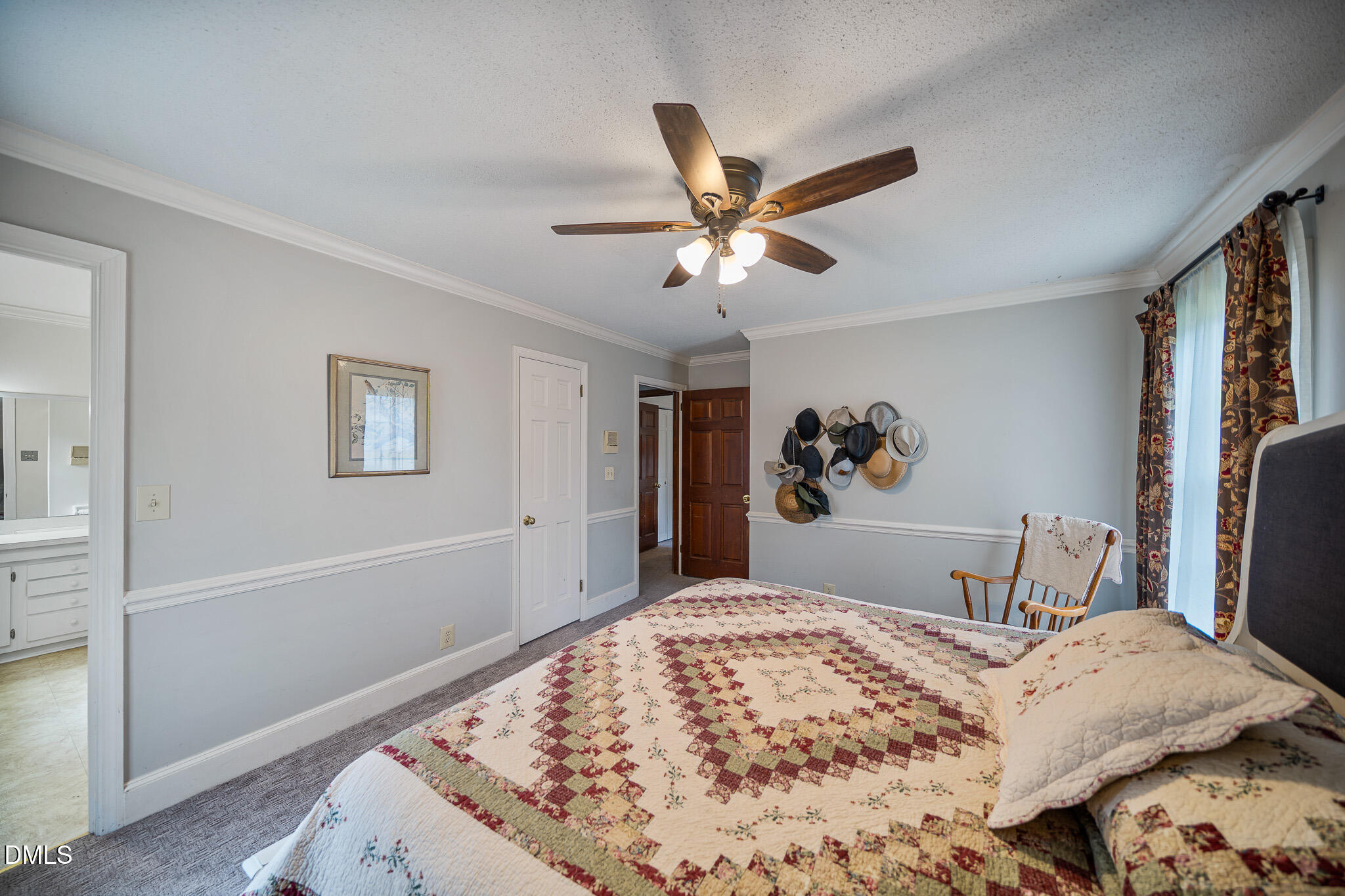79 South Pleasant Street Angier, NC 27501 - Photo 28 of 52 a bedroom with a bed and a chandelier