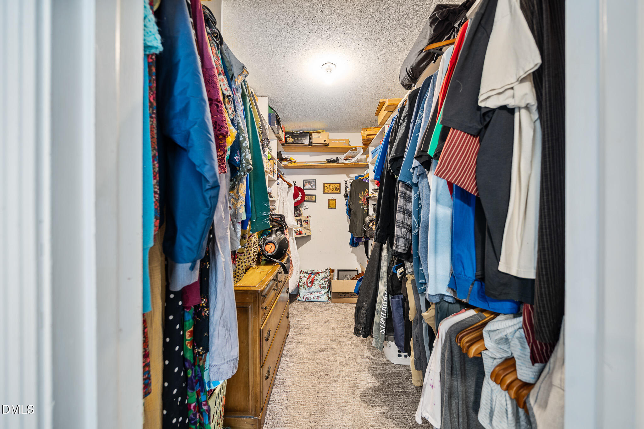 79 South Pleasant Street Angier, NC 27501 - Photo 32 of 52 a view of walk in closet with clothes and shoes