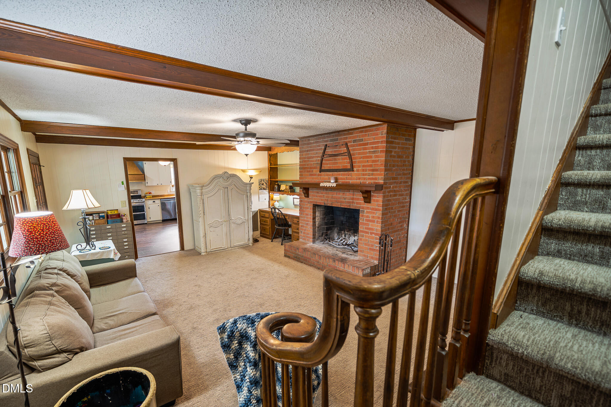 79 South Pleasant Street Angier, NC 27501 - Photo 38 of 52 a living room with furniture a fireplace and a floor to ceiling window