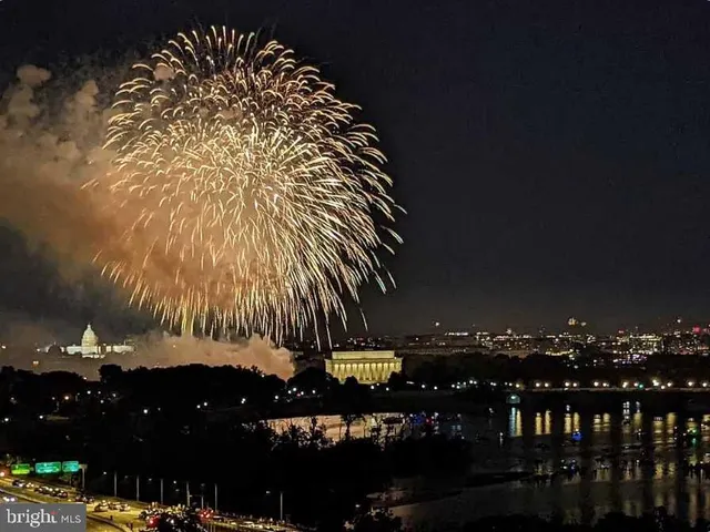 a view of a workspace with furniture and floor to ceiling window
