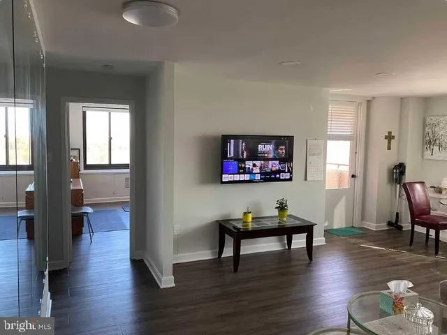 a living room with furniture and floor to ceiling window