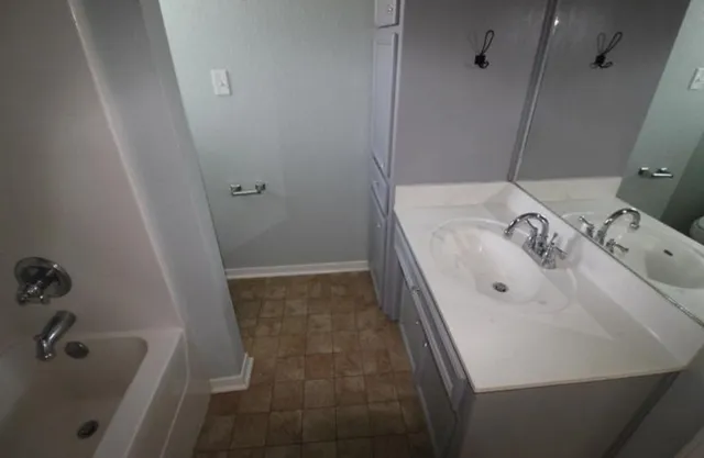 a bathroom with a bathtub and shower