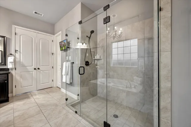 a large kitchen with a sink and stainless steel appliances