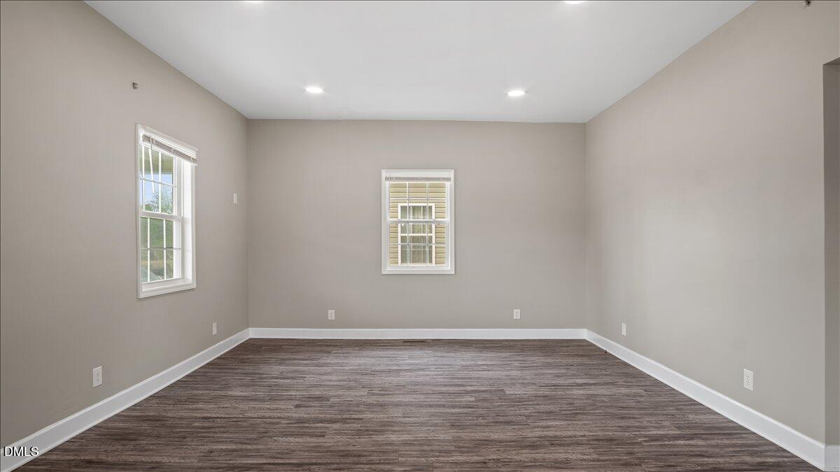 1284 Railroad Road Henderson, NC 27536 - Photo 10 of 35 a view of an empty room with wooden floor and a window