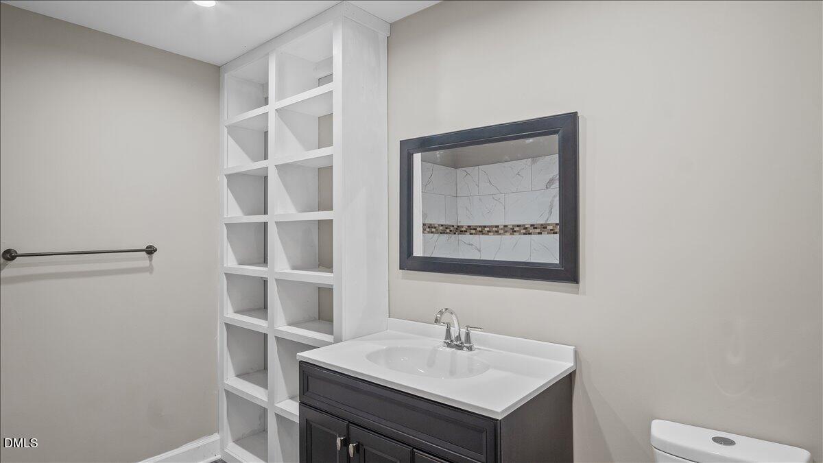 1284 Railroad Road Henderson, NC 27536 - Photo 15 of 35 a bathroom with a sink a toilet and a mirror