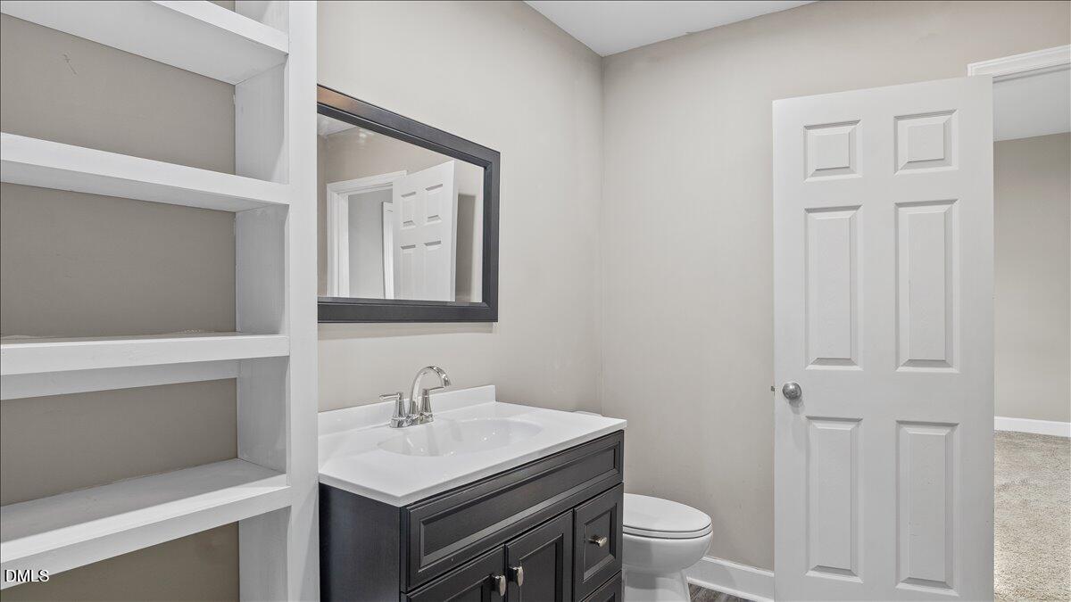 1284 Railroad Road Henderson, NC 27536 - Photo 16 of 35 a bathroom with a sink toilet and a mirror