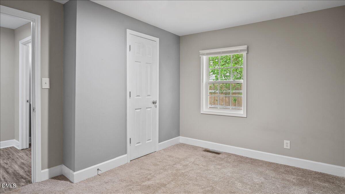 1284 Railroad Road Henderson, NC 27536 - Photo 19 of 35 an empty room with windows