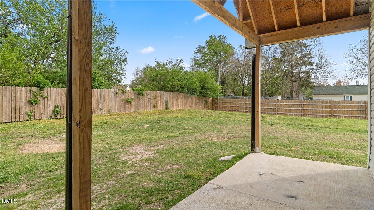 1284 Railroad Road Henderson, NC 27536 - Photo 28 of 35 a backyard of a house with a fountain and a yard
