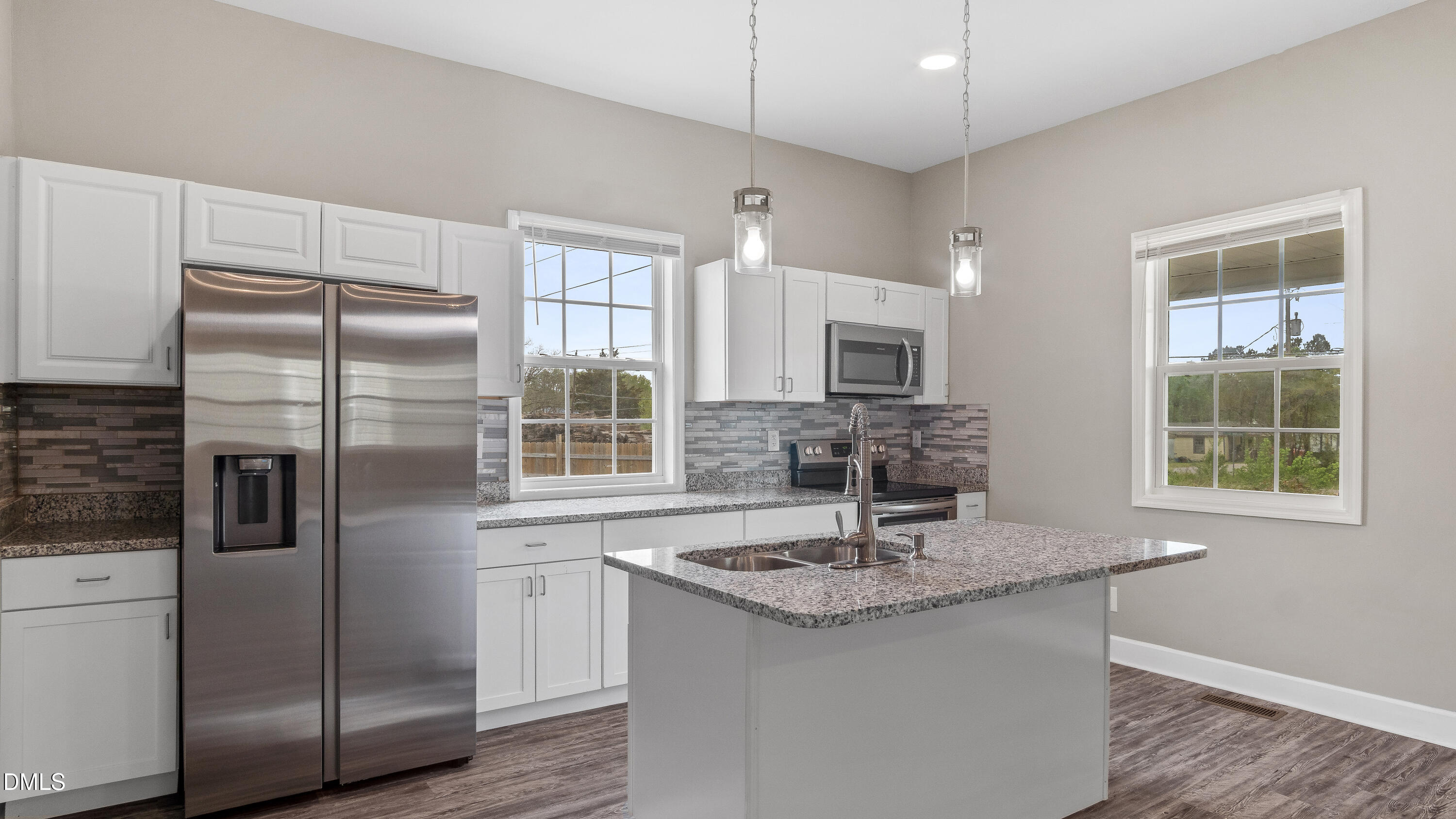 1284 Railroad Road Henderson, NC 27536 - Photo 4 of 35 a kitchen with stainless steel appliances granite countertop a sink and a refrigerator