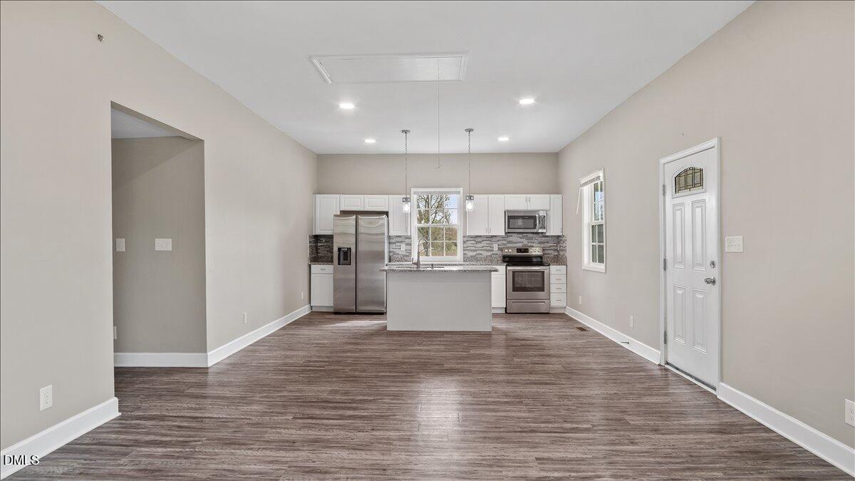 1284 Railroad Road Henderson, NC 27536 - Photo 5 of 35 a view of kitchen dining table wooden cabinets and refrigerator