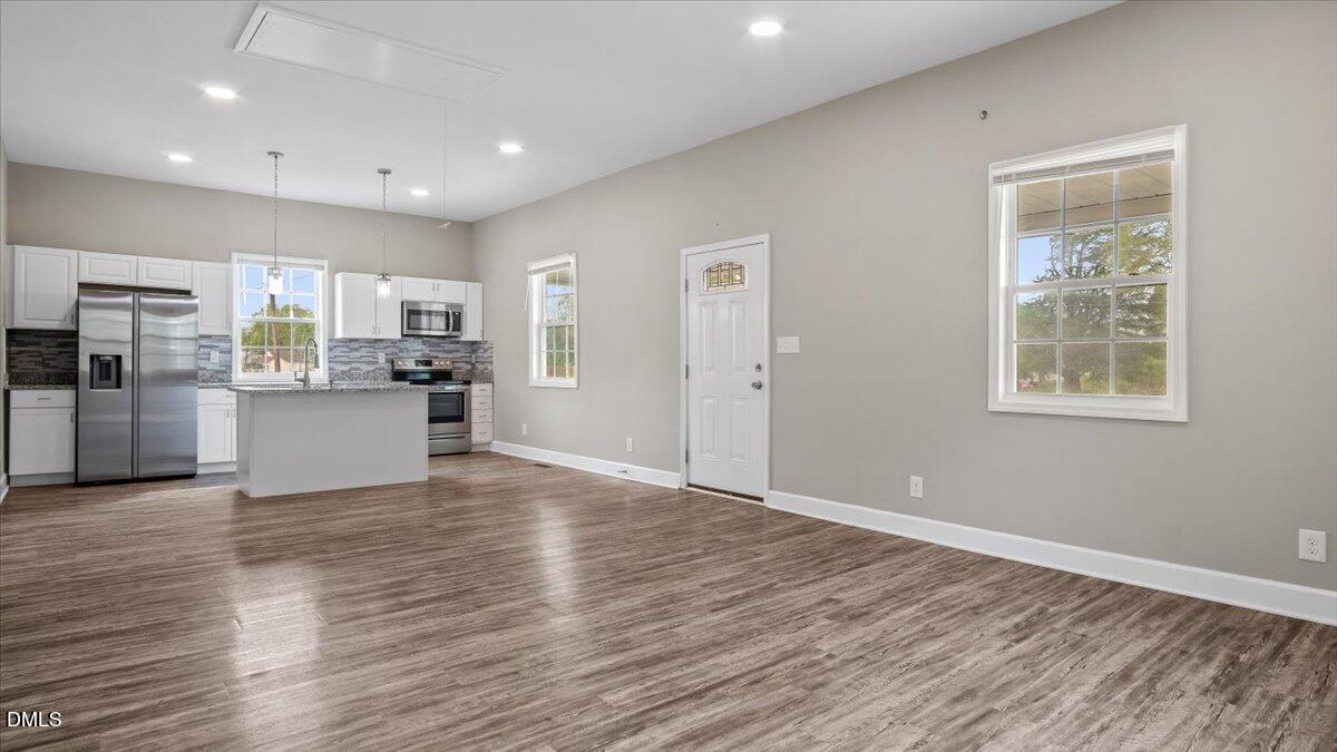 1284 Railroad Road Henderson, NC 27536 - Photo 7 of 35 a view of a kitchen with a sink a refrigerator and window