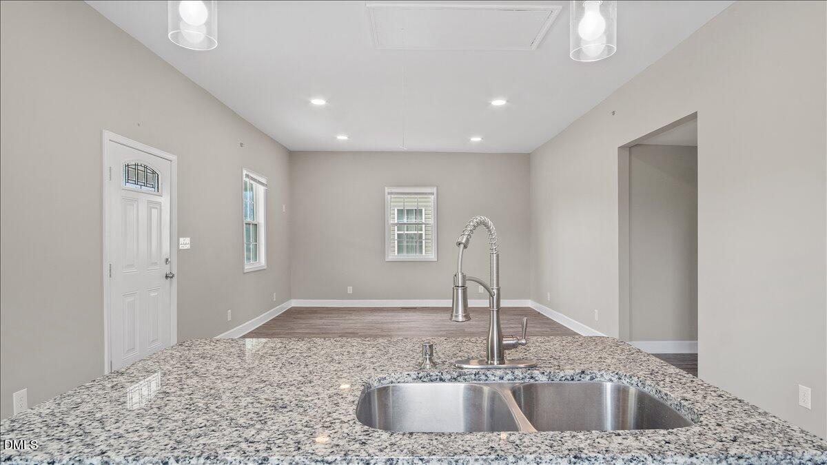 1284 Railroad Road Henderson, NC 27536 - Photo 9 of 35 a kitchen with a sink and a large mirror
