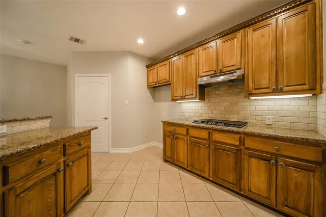 a kitchen with stainless steel appliances granite countertop a sink and cabinets
