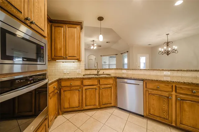 a kitchen with stainless steel appliances a stove sink and cabinets