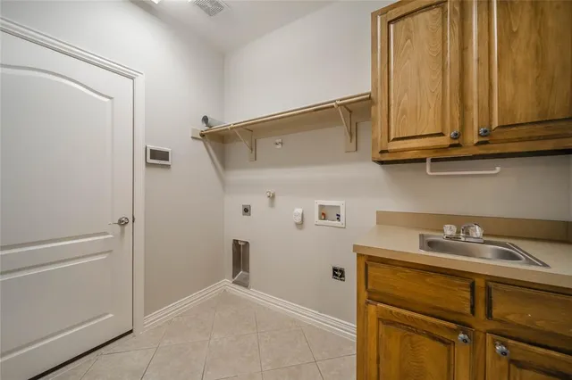 a view of an empty room with a fireplace and wooden floor