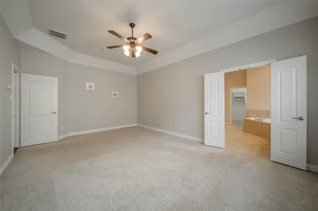 a bathroom with a tub a sink and a mirror