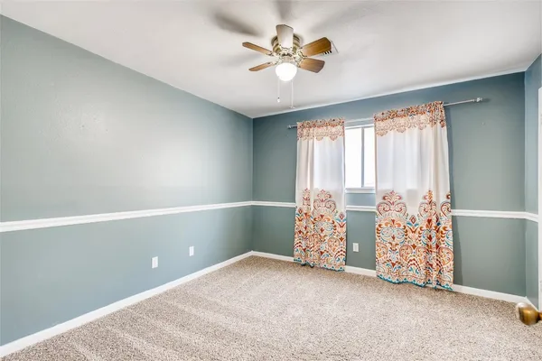 a view of a big room with closet and a ceiling fan