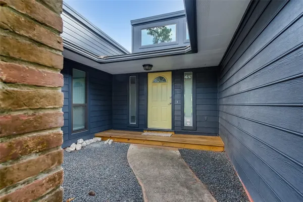 a view of empty room with fireplace and wooden floor
