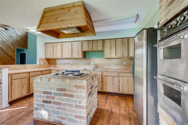 a kitchen with granite countertop stainless steel appliances and wooden cabinets