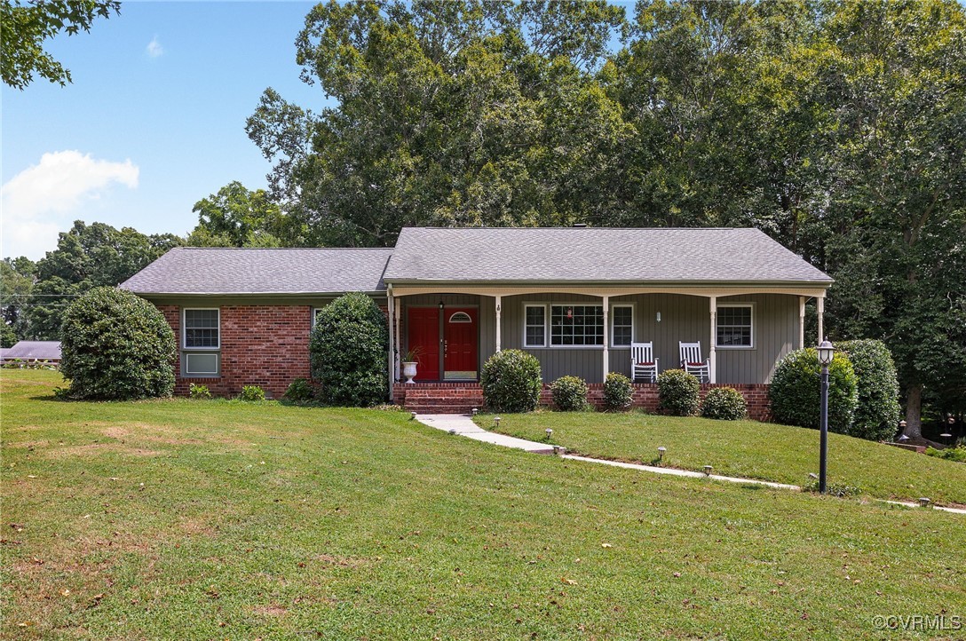 a front view of a house with a yard and porch