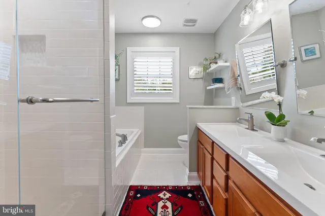 a bathroom with a sink a bathtub a and a shower