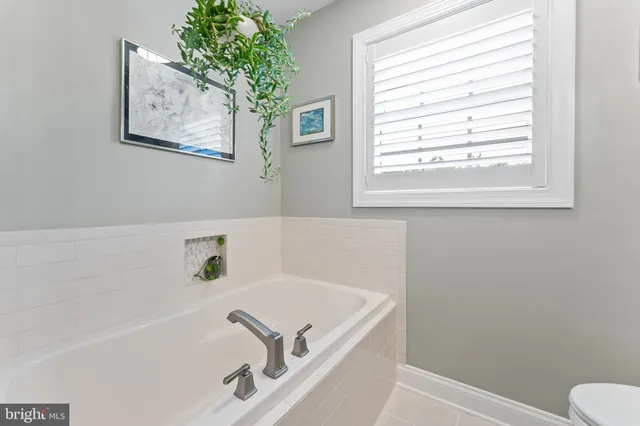 a bathroom with a bathtub and a window