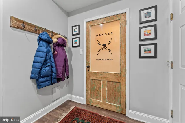 a view of a hallway with white walls and a window