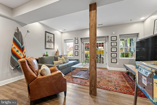 a living room with furniture and a wooden floor