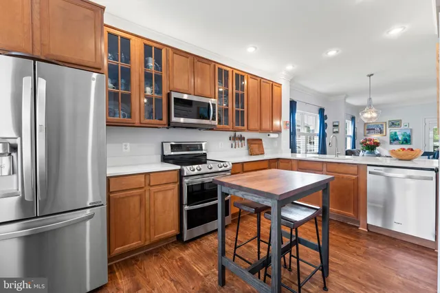 a kitchen with stainless steel appliances granite countertop a refrigerator stove microwave and sink