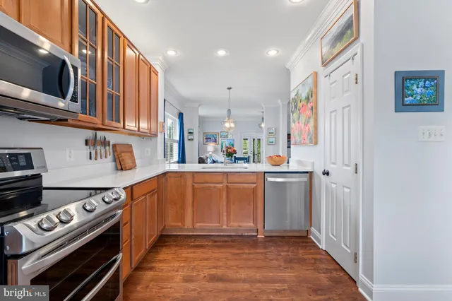 a kitchen with stainless steel appliances granite countertop a refrigerator and a stove