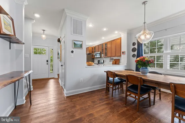 a view of a dining room with furniture window and wooden floor