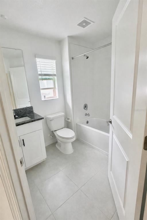 8271 Corner Pine Way New Port Richey, FL 34655 - Photo 12 of 16 a bathroom with a toilet a sink a bath tub and a window