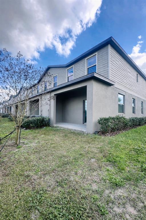 8271 Corner Pine Way New Port Richey, FL 34655 - Photo 15 of 16 a front view of a house with garden