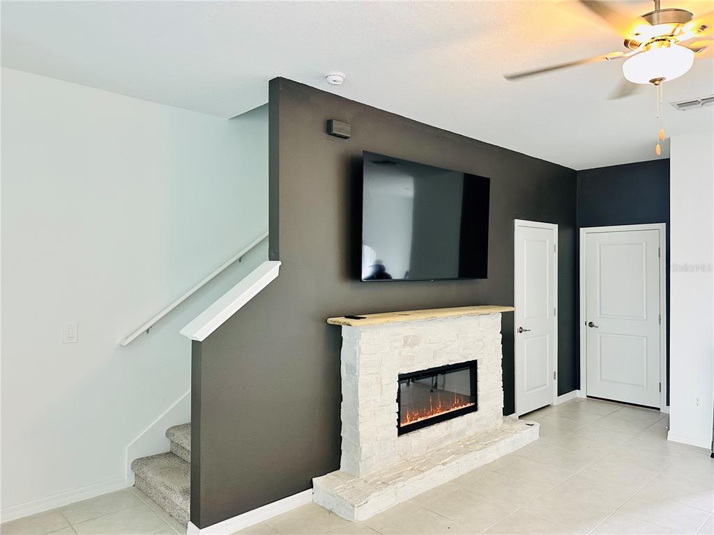 8271 Corner Pine Way New Port Richey, FL 34655 - Photo 5 of 16 a view of a livingroom with an empty space and a fireplace