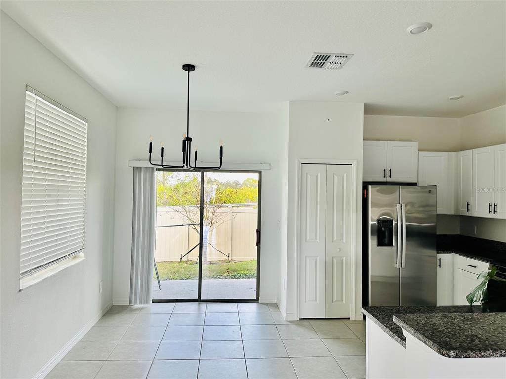 8271 Corner Pine Way New Port Richey, FL 34655 - Photo 6 of 16 a kitchen with stainless steel appliances granite countertop a refrigerator and a sink
