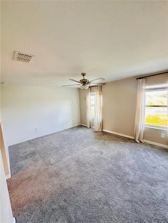 an empty room with a empty space and a ceiling fan